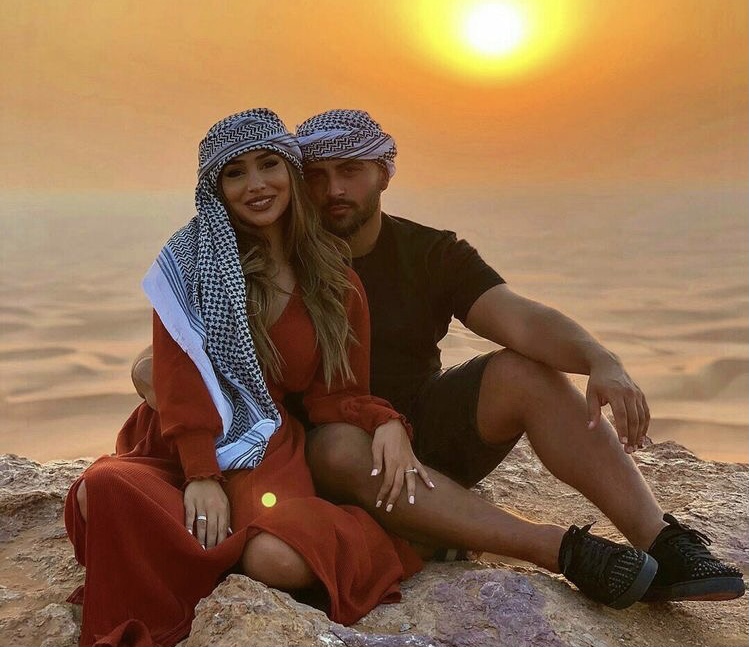 A man and a woman in the deserts of Dubai at sunset