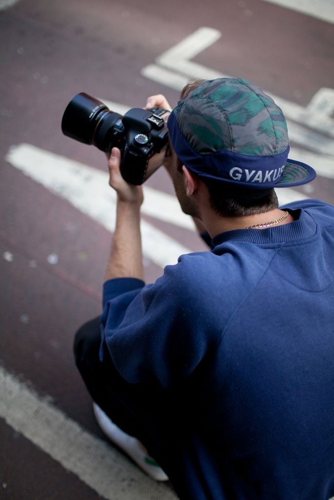 Male photographer while shooting with the proper lens