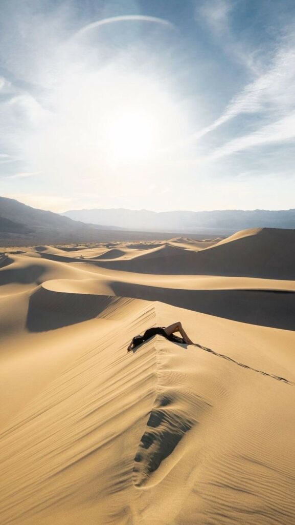 Photo of a girl sleeping on the sands of the Dubai desert during the day